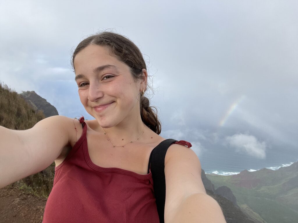 selfie of annabelle in front of a small rainbow in Hawaii